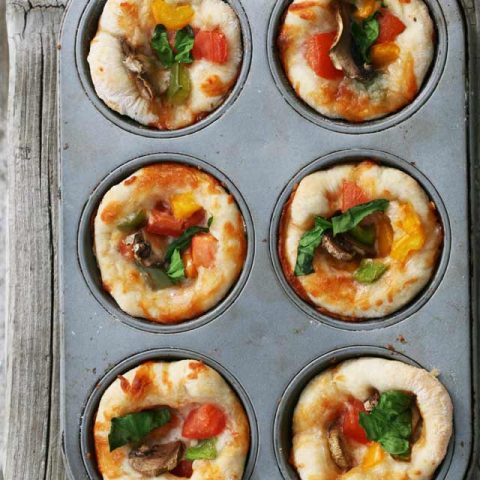 Mini pizzas made in a muffin tin: Use your leftover pizza dough and make these super cheap appetizers!