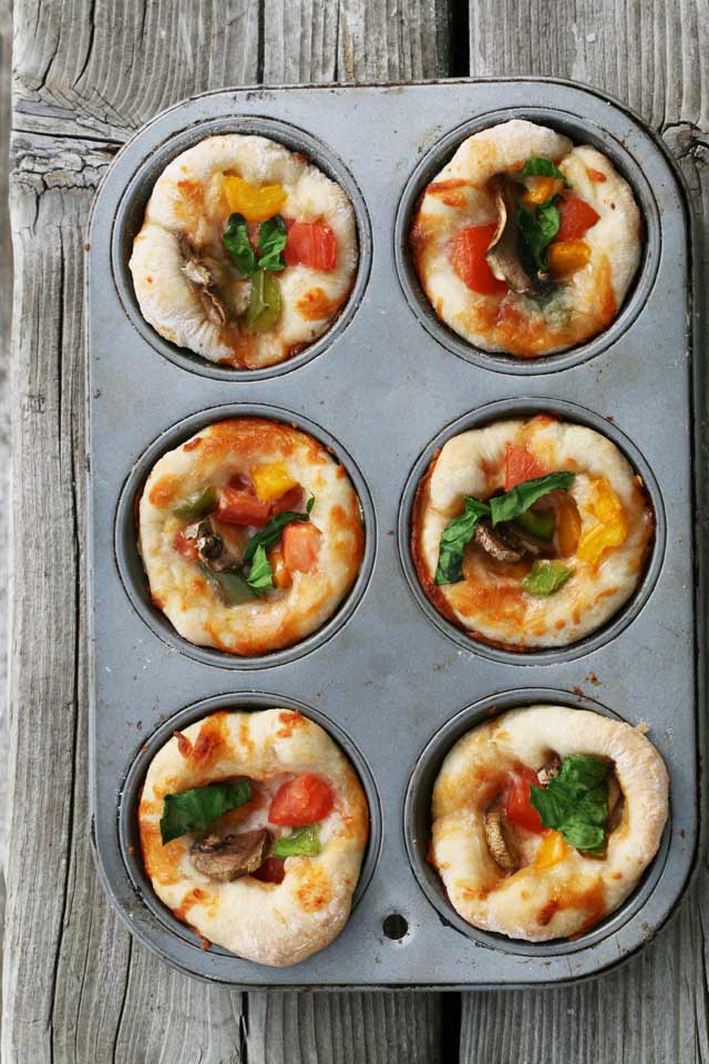 Mini pizzas made in a muffin tin. Completely customizable. Click through for recipe.