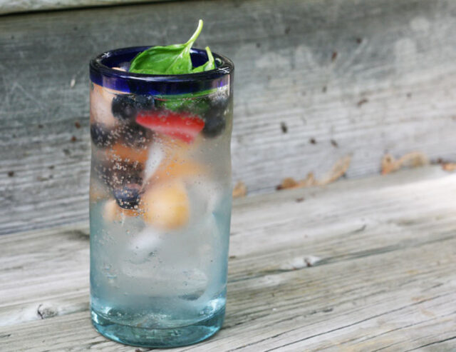 Put frozen fruit in sparkling water for a refreshing beverage