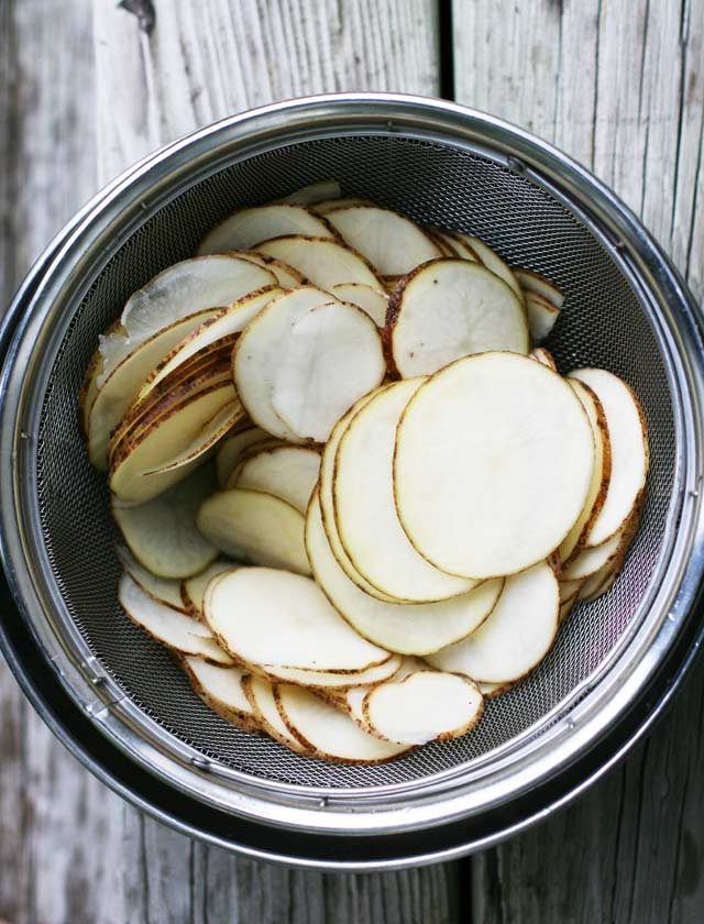 Sliced potatoes, ready to fry and make into homemade potato chips.