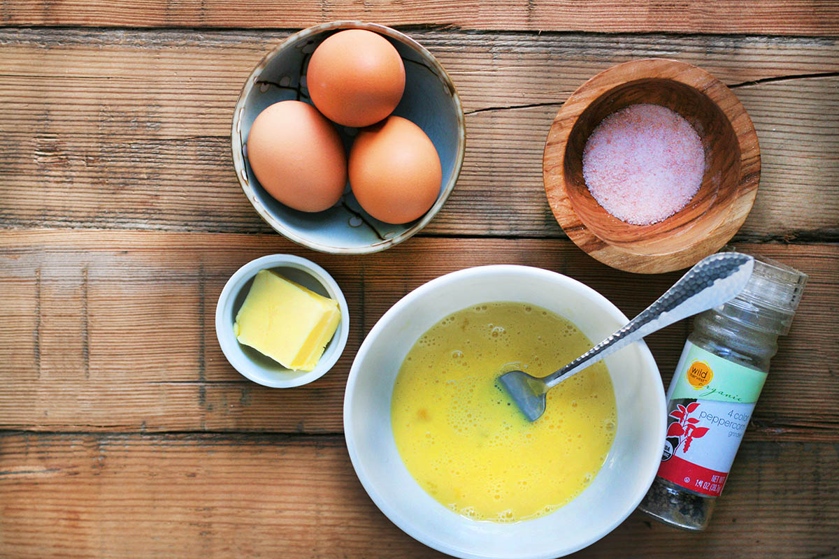 Ingredients for simple, delicious, perfect scrambled eggs: Eggs, butter, salt, and pepper. Click through for detailed instructions to make perfect scrambled eggs!