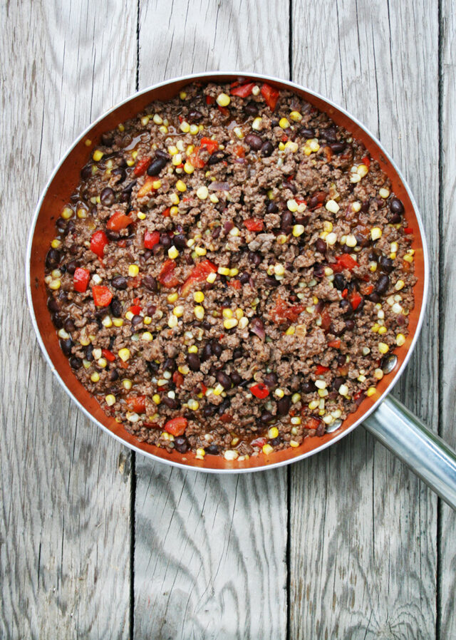 Mexican ground beef skillet: Hamburger, veggies, flavorful sauce, and toppings make for a delicious dinner or appetizer recipe.