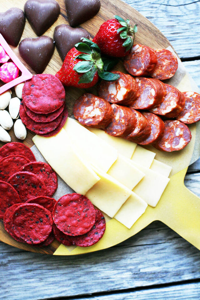 A Valentine's Day snack board: Red, pink, and white snacks perfect for a Valentine's Day celebration.