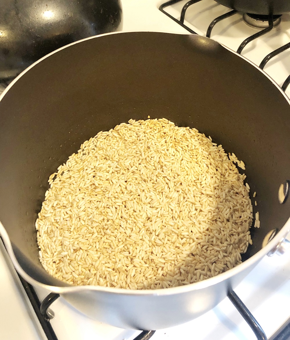 Toasting rice, an essential step in making homemade Mexican rice at home.
