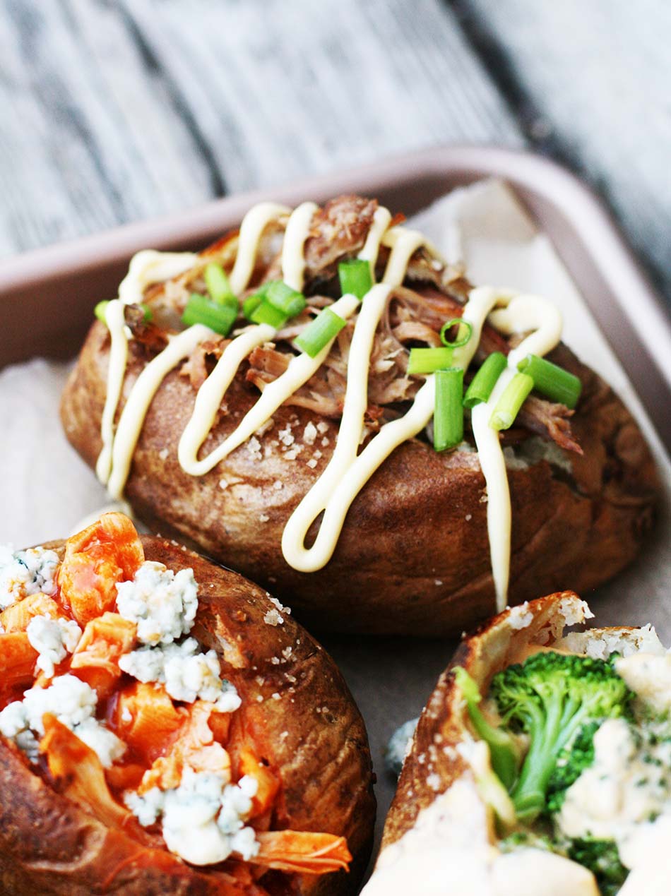 Inexpensive loaded baked potato recipes: This one is topped with pulled pork, Japanese mayonnaise, and chopped green onion.