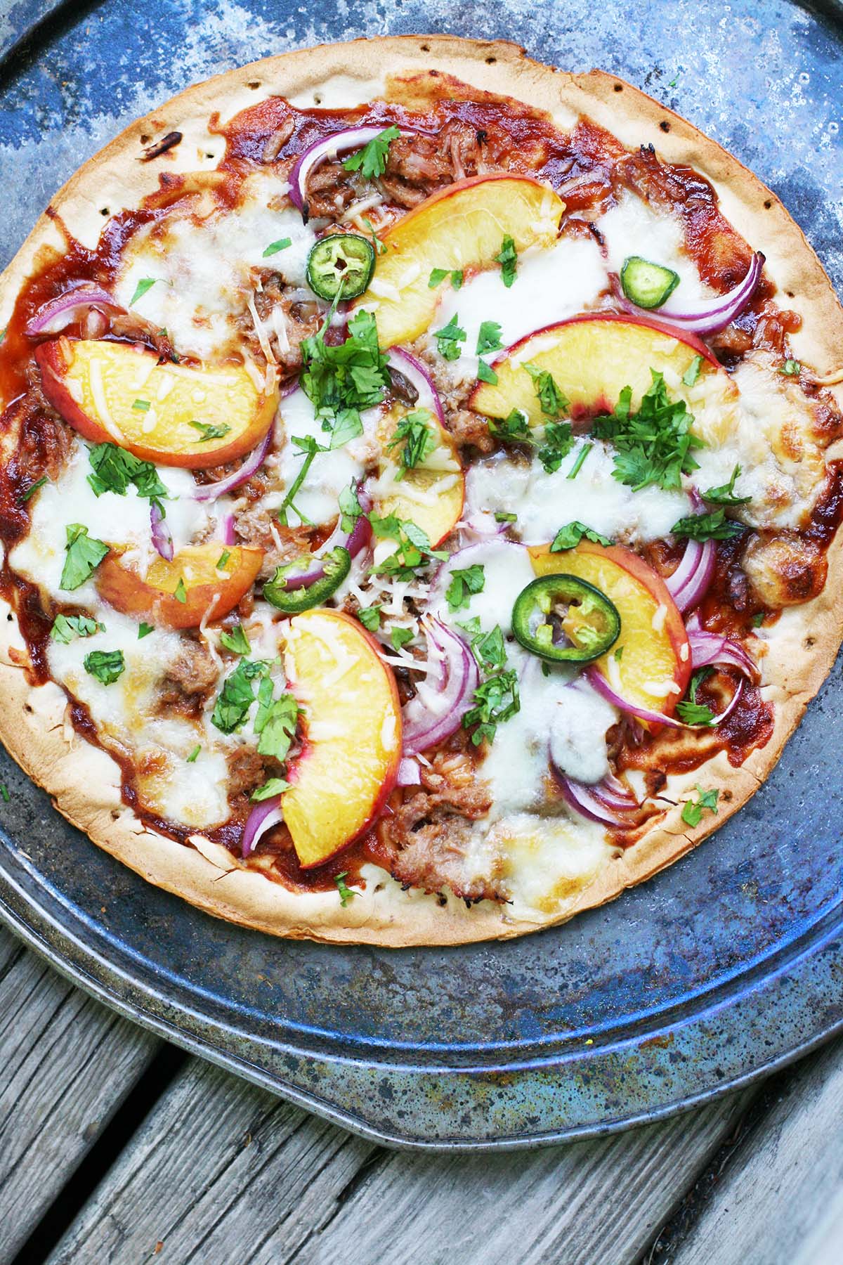 Fruit on pizza: Try this peach, pulled pork, jalapeno, and red onion pizza!