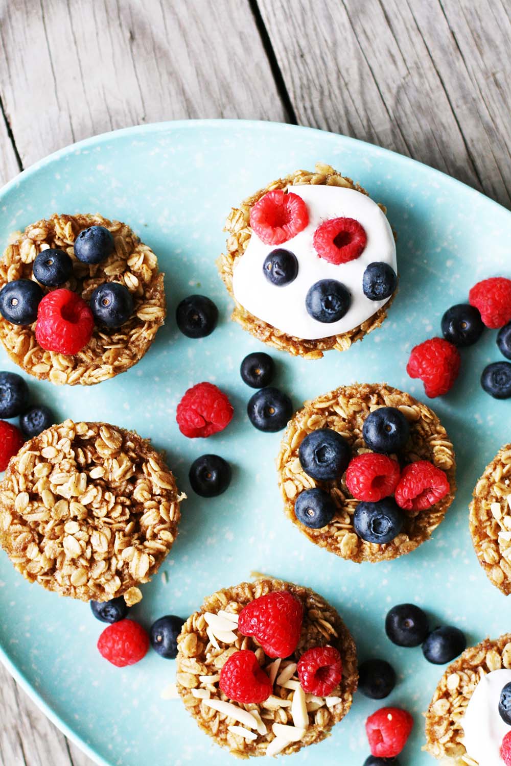Baked oatmeal cups, topped with fresh berries, yogurt, nuts... and more! Click through for recipe.