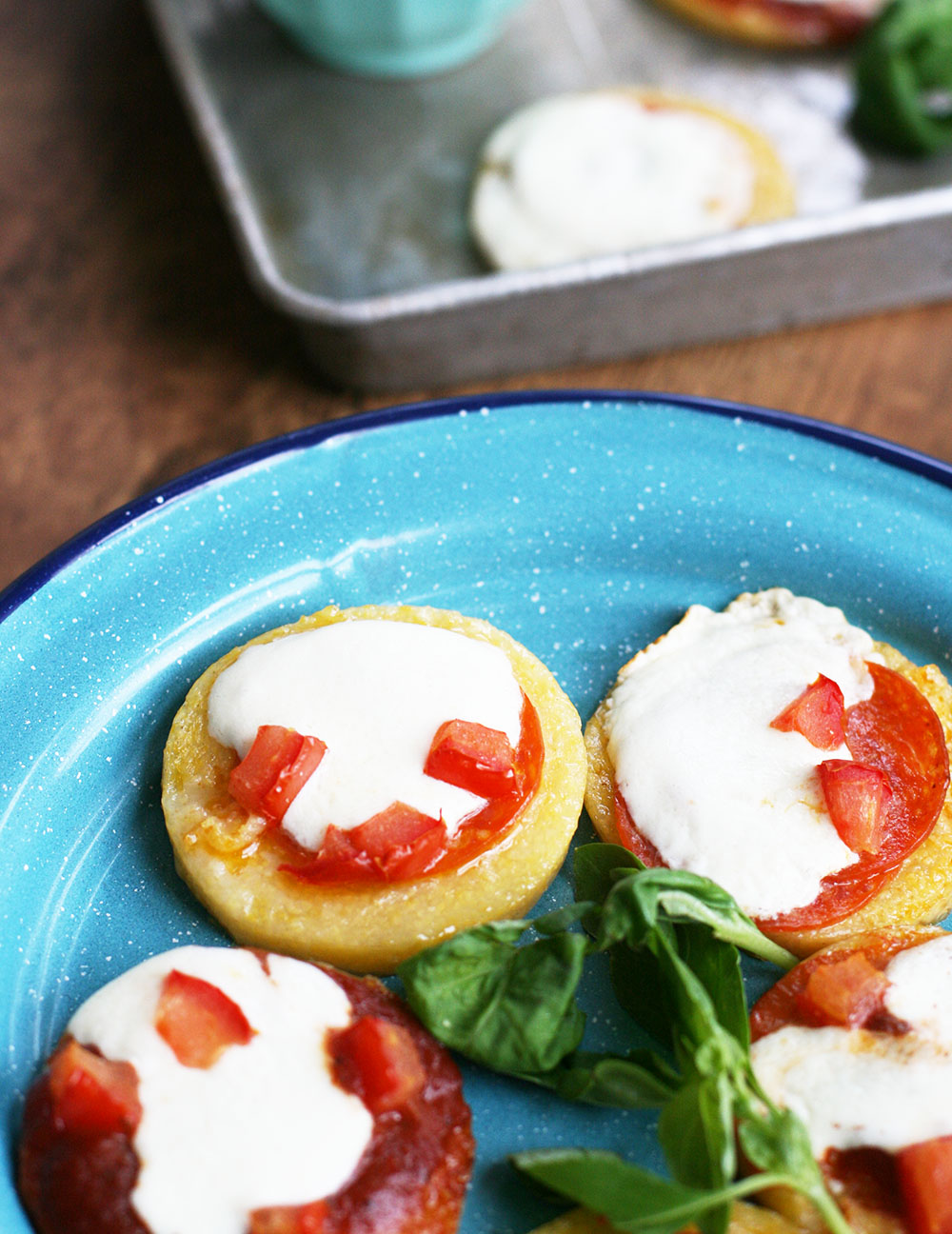 Polenta pizza bites: Slices of polenta topped with tomato sauce, cheese, and other toppings.
