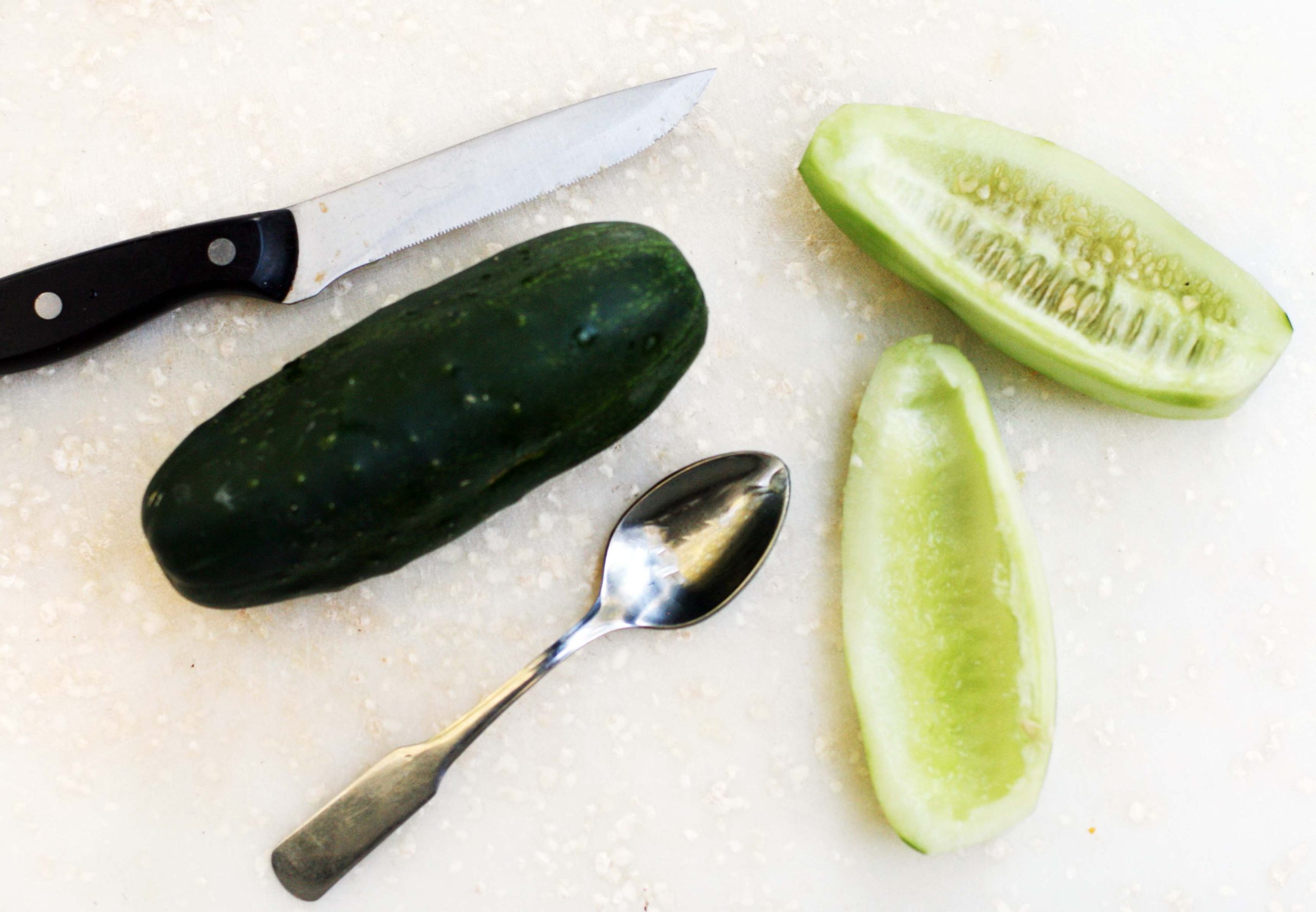 Cutting cucumbers and removing seeds to make homemade Christmas pickles.