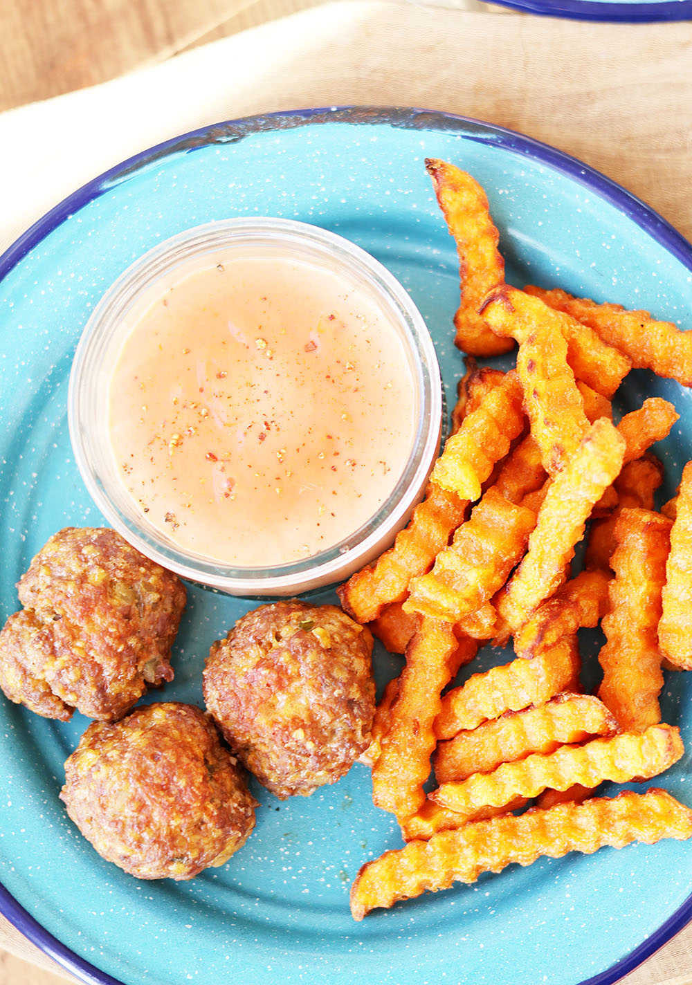 Cheeseburger meatballs served with a simple burger sauce & Sweet potato fries.