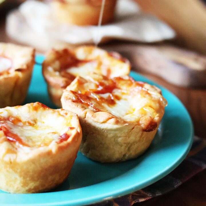 Muffin pizzas, drizzled with hot honey. Click through for recipe.